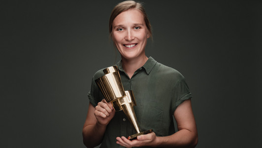 Dorothea Taube hält den Kulturpreis Bayern 2022 in die Kamera